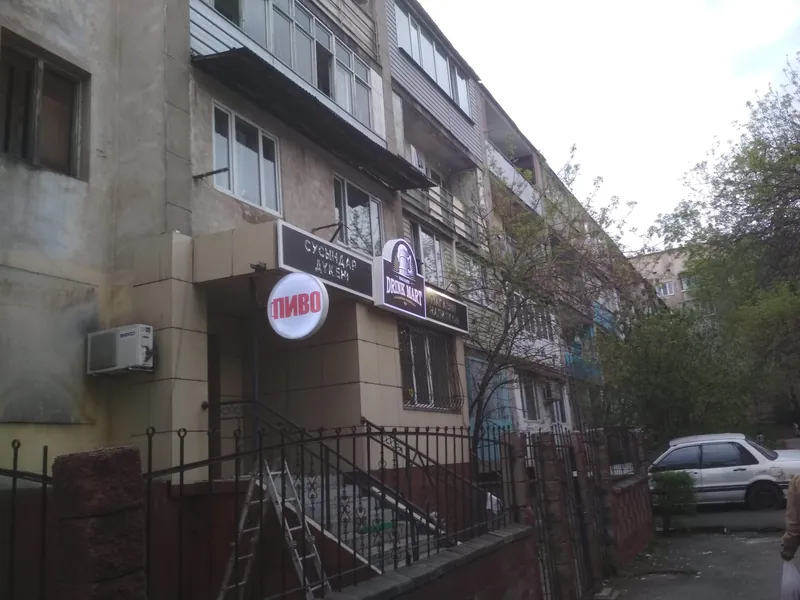 Фасад магазина с готовыми вывесками: круглый световой короб «ПИВО» и надпись «Сусындар дүкені»